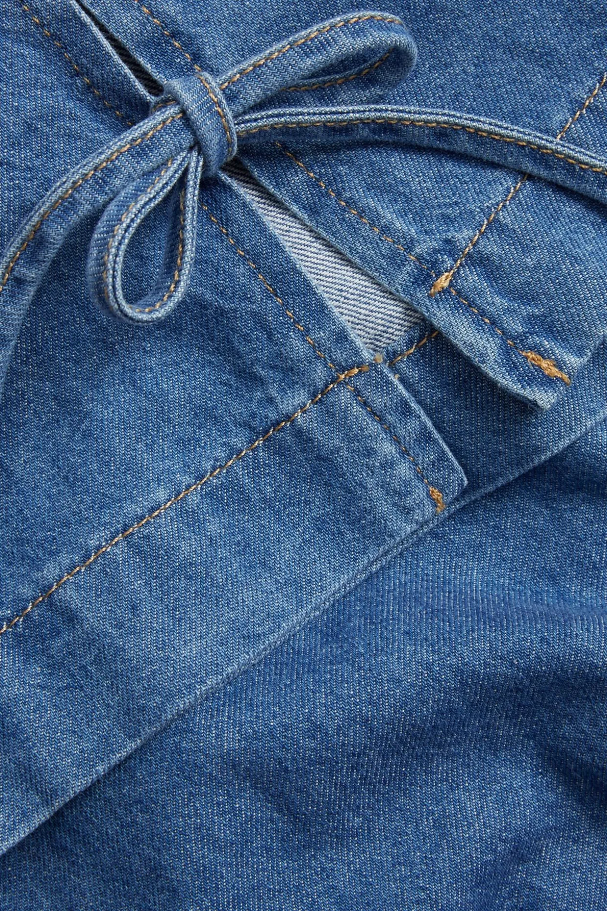 Ermeløs denimtopp med knytebånd i siden