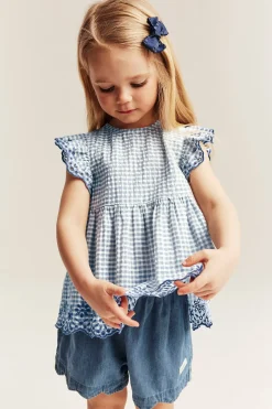 Peplum-bluse med broderi