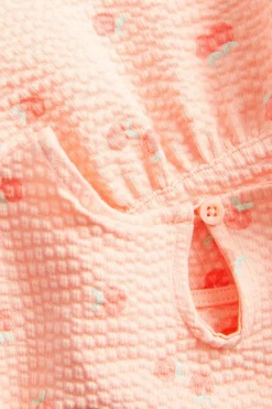 Peplum-topp med ferskner i seersucker