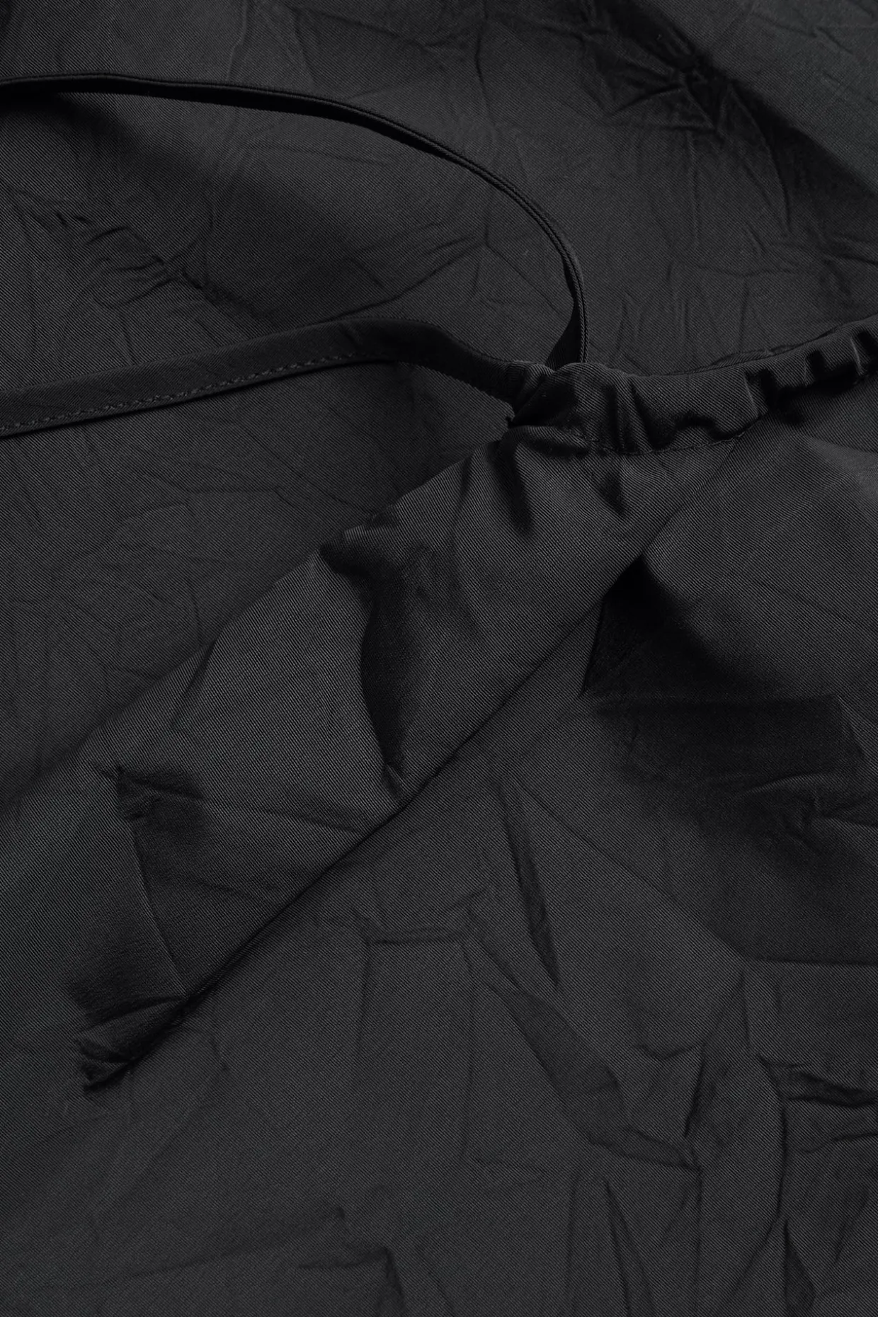 Singlet med draperingsdetaljer