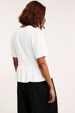 Strukturert topp med peplum og korte ermer